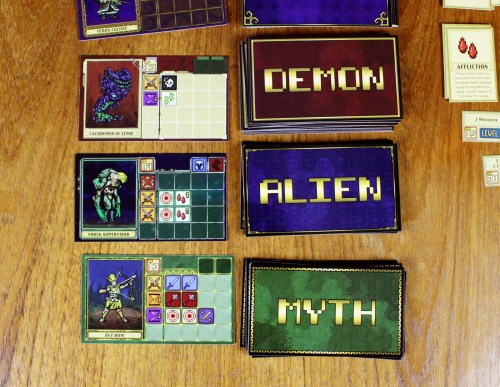 A sample of 3 monsters from the Demon, Alien, and Myth decks