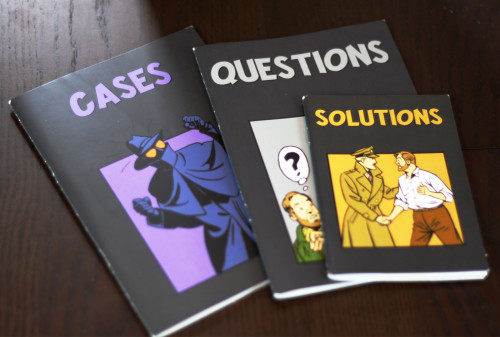 These are the casebooks for the group. The "Cases" book includes some patter that sets the grounds for the case, the "Questions" book offers what players are trying to solve, and the "Solutions" book tells the players why they are wrong.